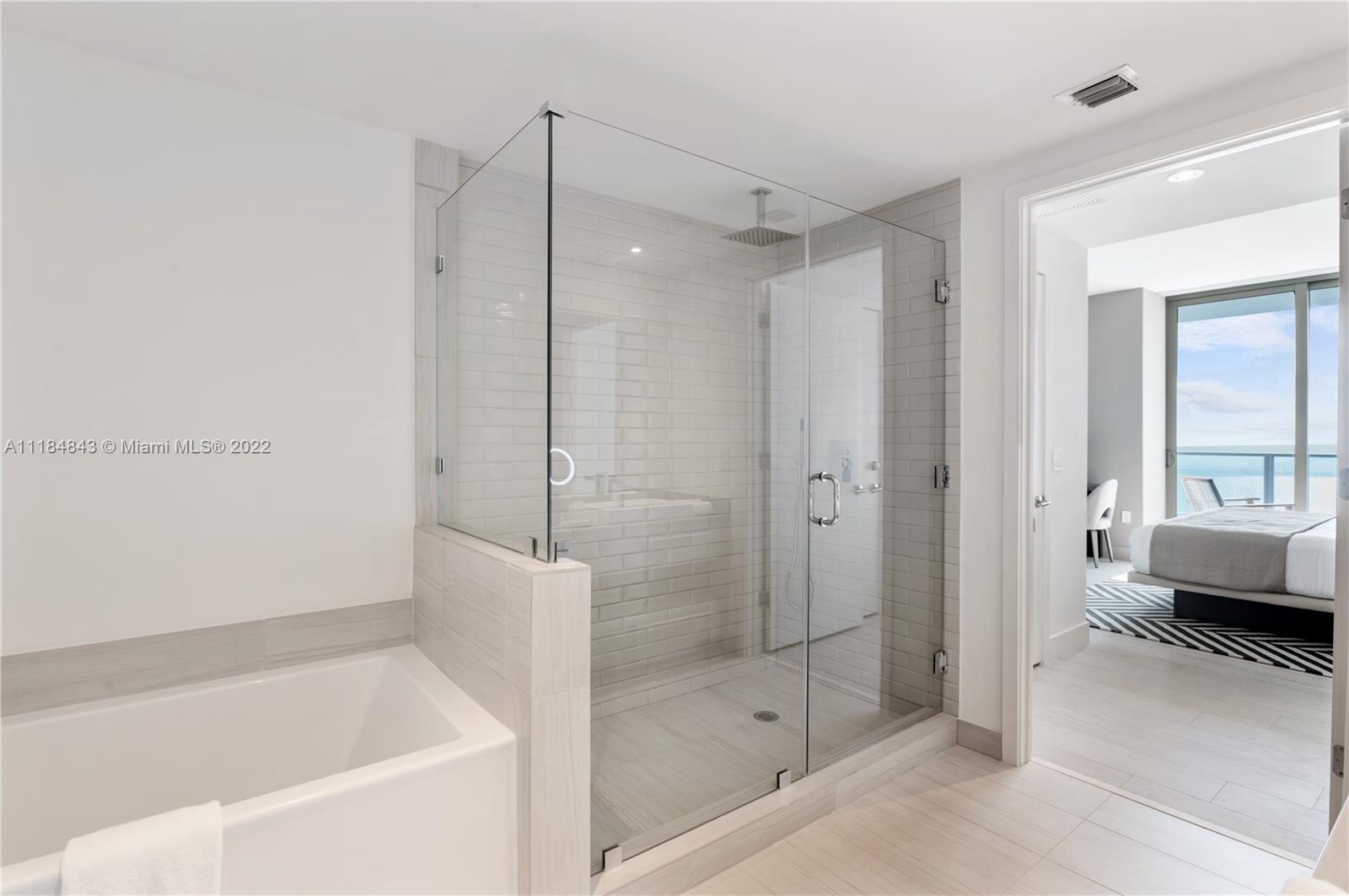4010 South Ocean Drive, Unit R1405 Hollywood, FL 33019 - Photo 13 of 67 a bathroom with a tub shower and sink