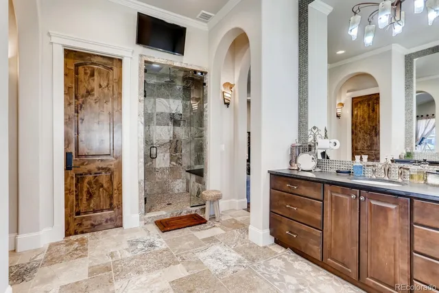 a bathroom with a granite countertop sink mirror vanity and toilet