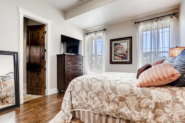 a bedroom with furniture and a chandelier
