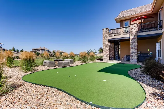 a view of a house with backyard porch and sitting area