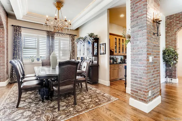 a view of a dining room with furniture and chandelier