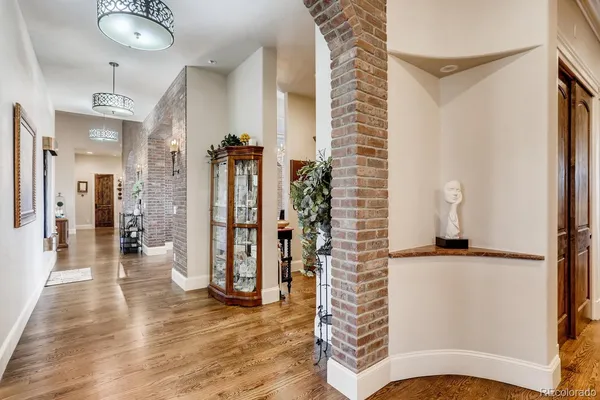 a kitchen with stainless steel appliances granite countertop a sink a stove and a dining table