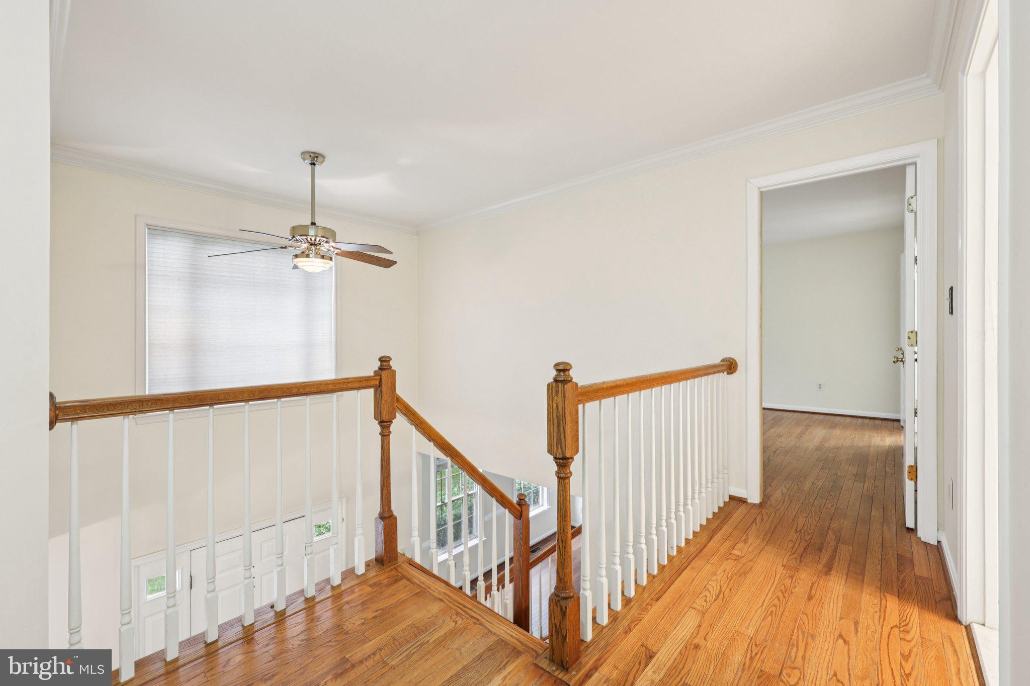 10457 Pineview Road Manassas, VA 20111 - Photo 16 of 55 a view of a hallway with wooden floor and staircase