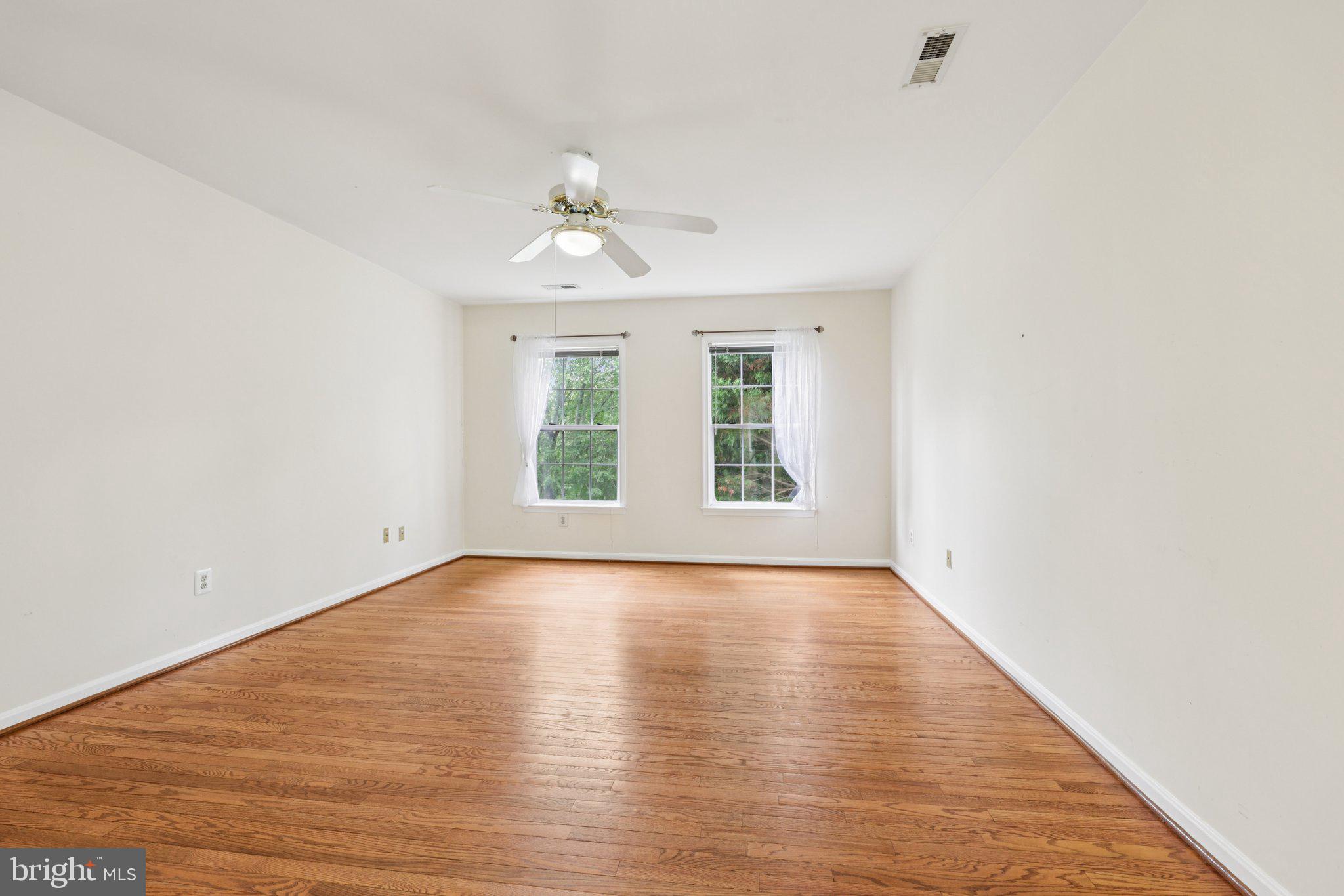 10457 Pineview Road Manassas, VA 20111 - Photo 17 of 55 an empty room with wooden floor and windows