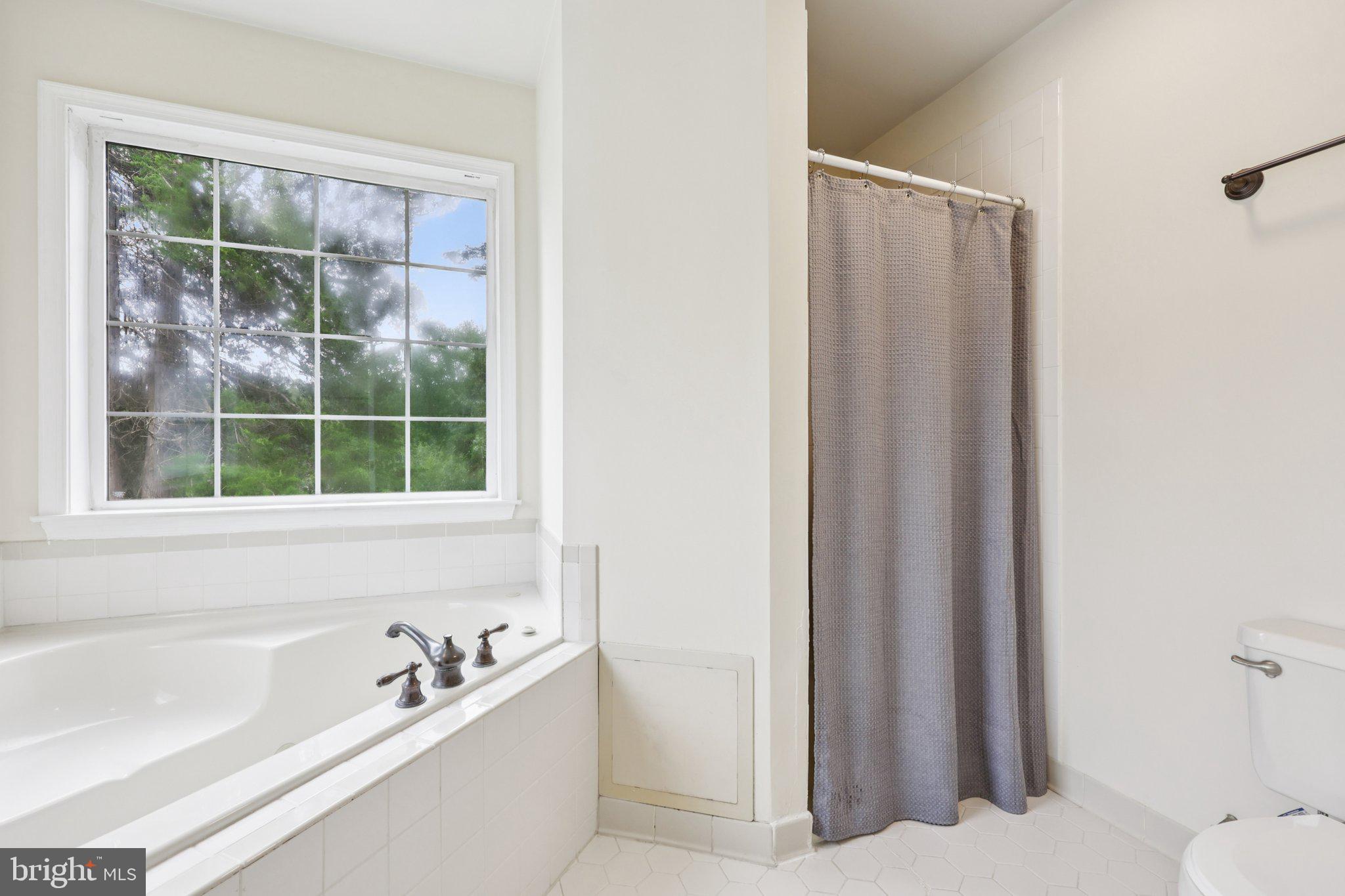 10457 Pineview Road Manassas, VA 20111 - Photo 22 of 55 a bathroom with a tub and shower