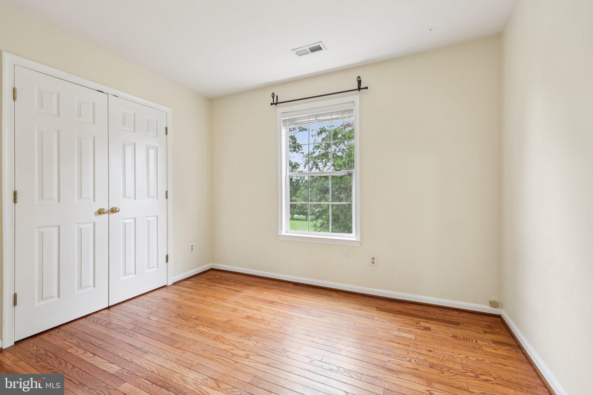 10457 Pineview Road Manassas, VA 20111 - Photo 23 of 55 an empty room with wooden floor and windows