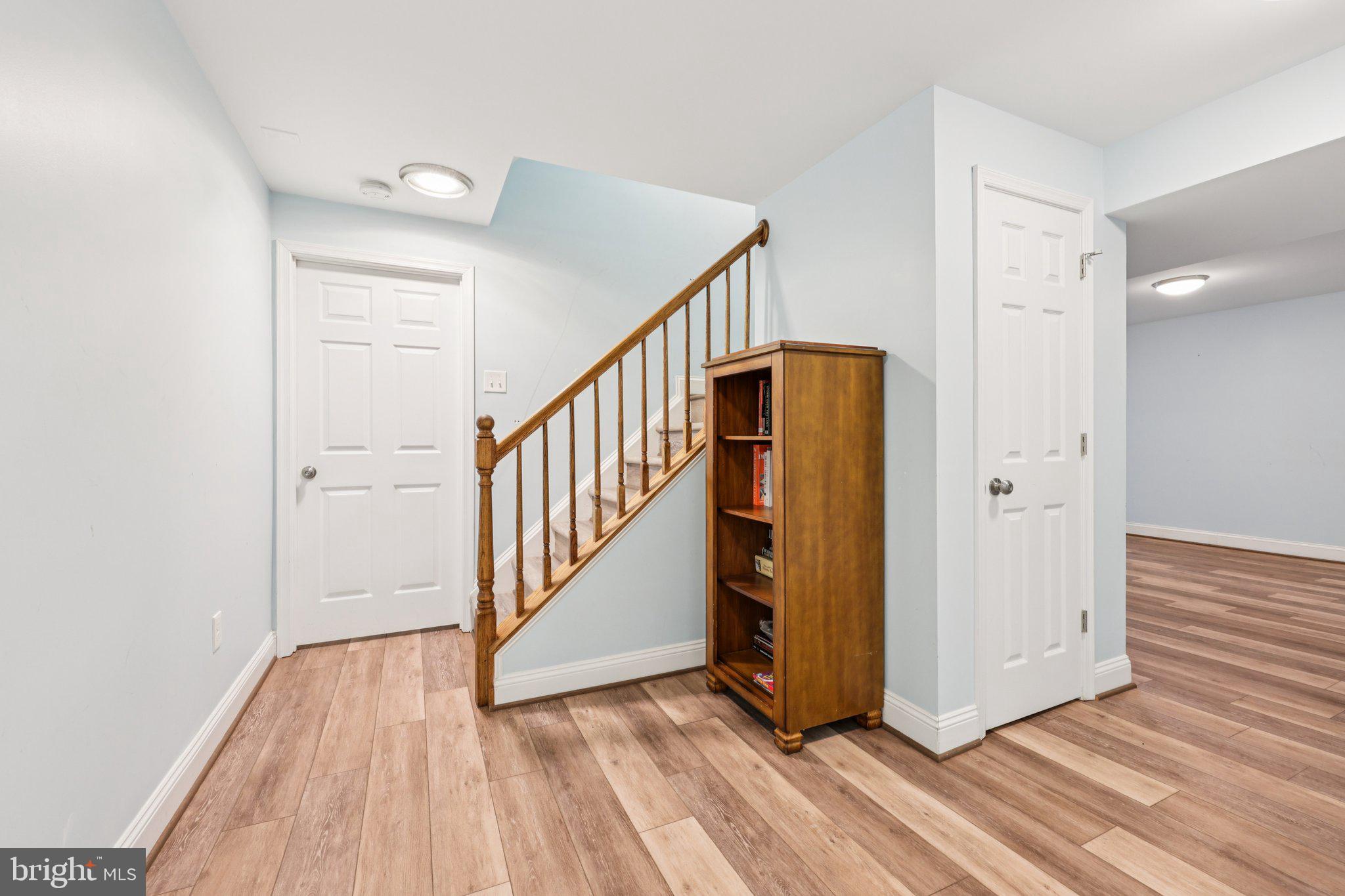 10457 Pineview Road Manassas, VA 20111 - Photo 29 of 55 a view of a hallway with wooden floor and staircase