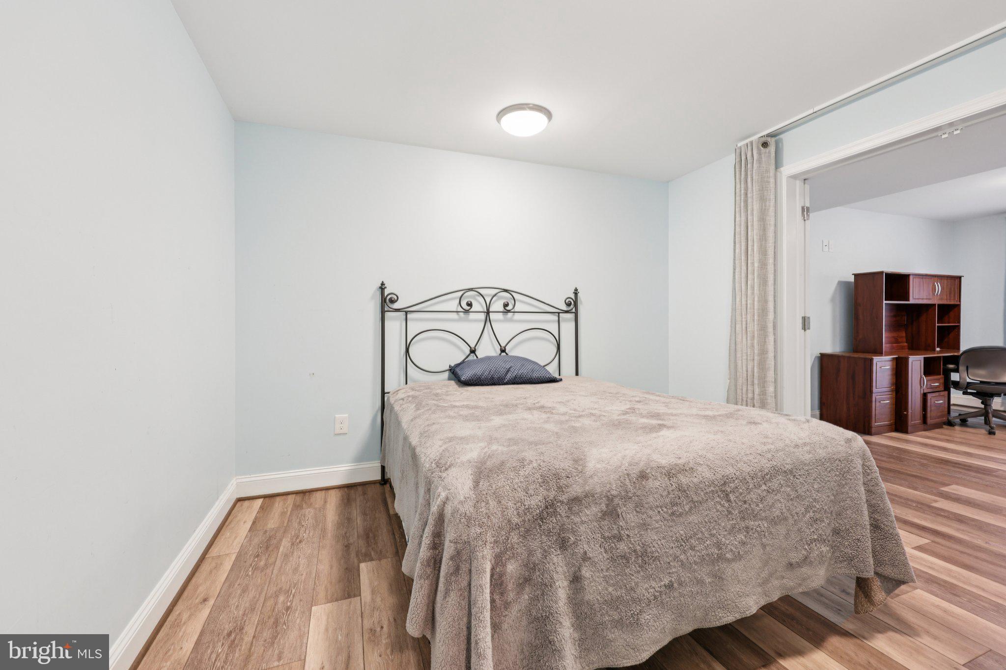 10457 Pineview Road Manassas, VA 20111 - Photo 30 of 55 a bedroom with a bed and a television