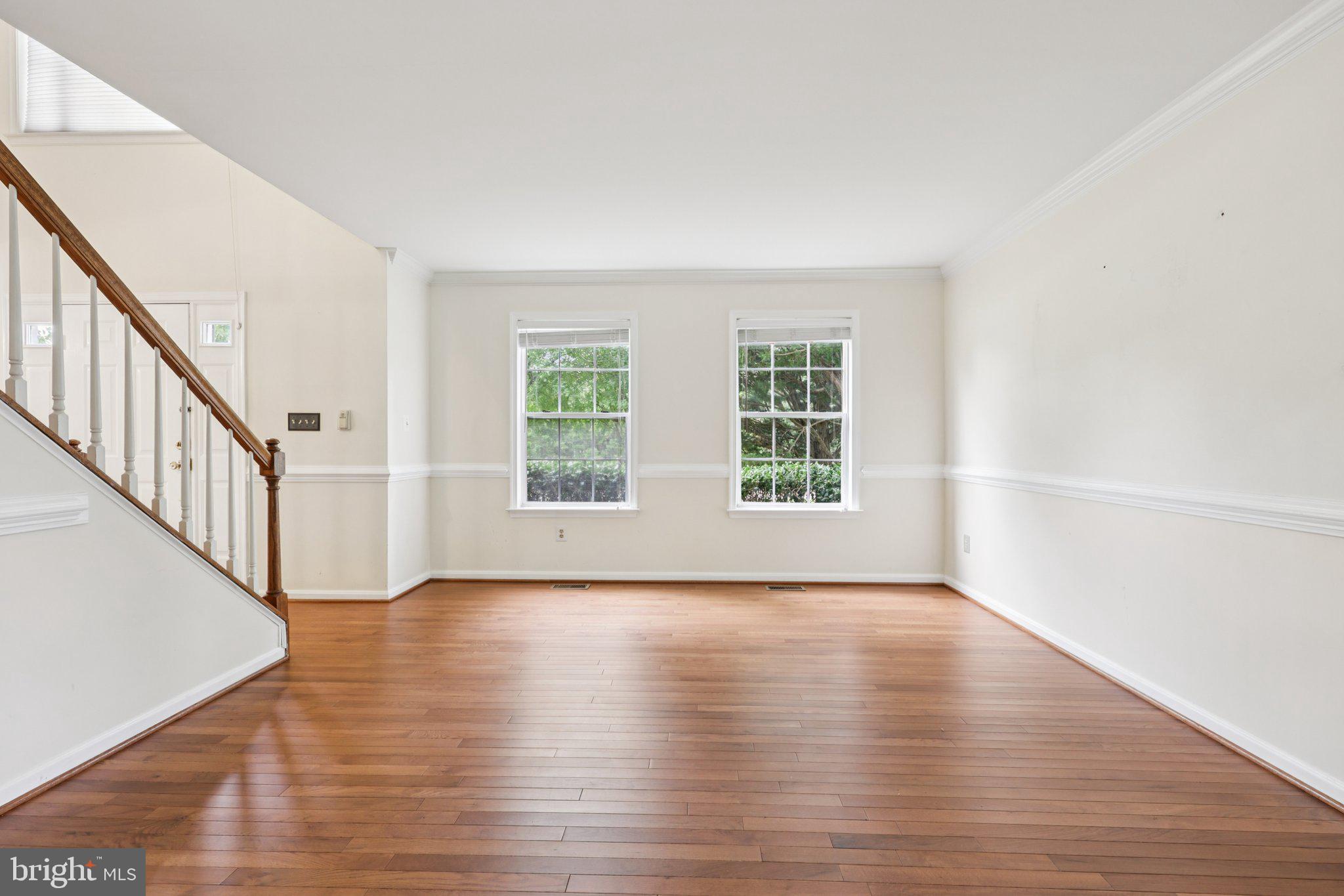 10457 Pineview Road Manassas, VA 20111 - Photo 3 of 55 a view of an empty room with wooden floor and window