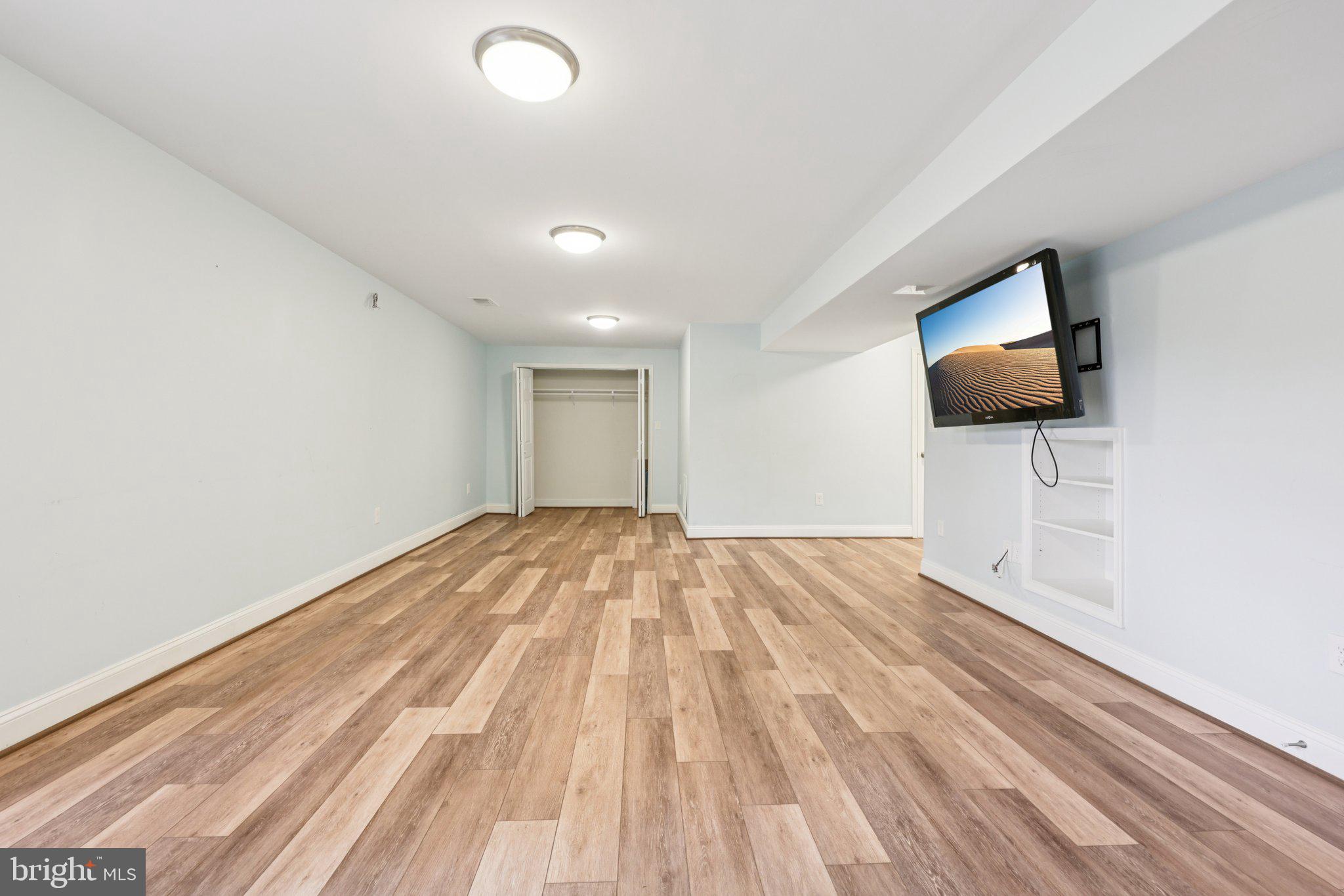 10457 Pineview Road Manassas, VA 20111 - Photo 35 of 55 a view of empty room with wooden floor and fan