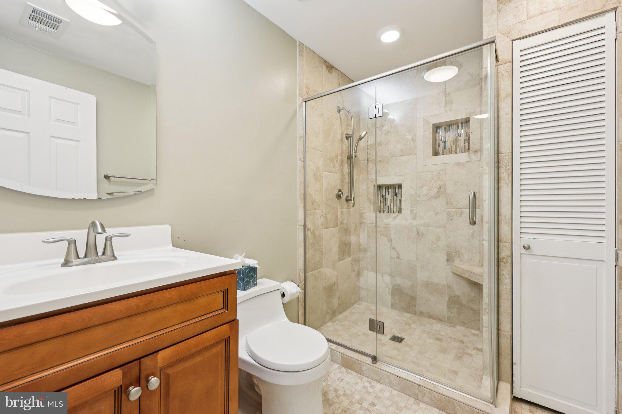 10457 Pineview Road Manassas, VA 20111 - Photo 36 of 55 a bathroom with a shower sink vanity mirror and toilet