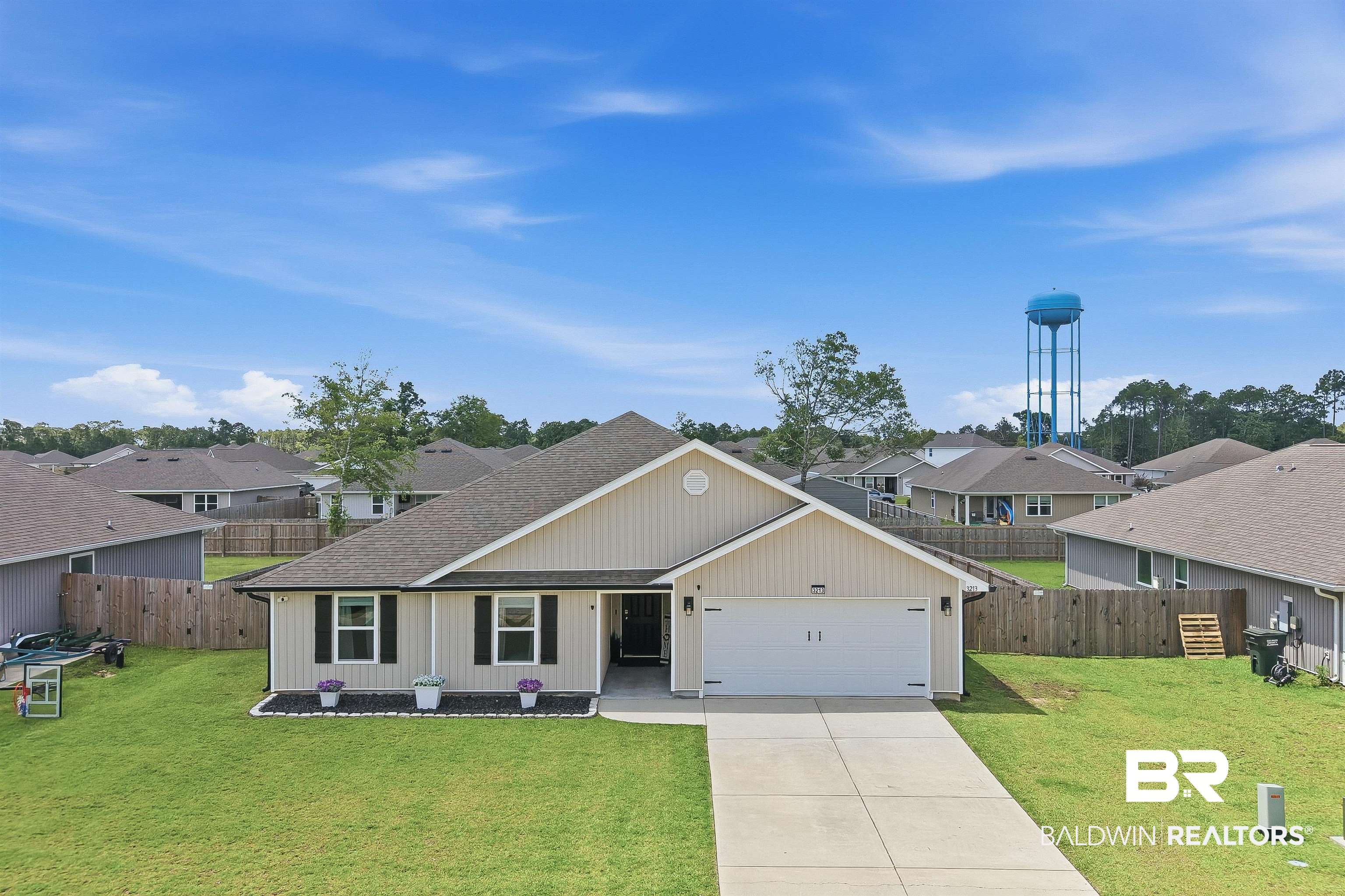3213 Camino Real Loop Lillian, AL 36549 - Photo 11 of 61 Single-story residence featuring light-colored siding, a dark roof, and a two-car garage