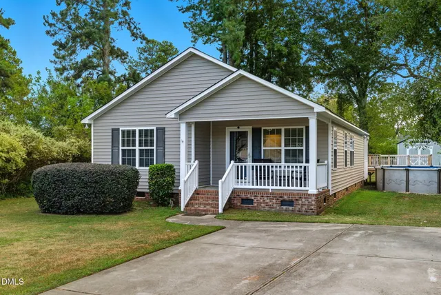 a house with a small yard and a large trees