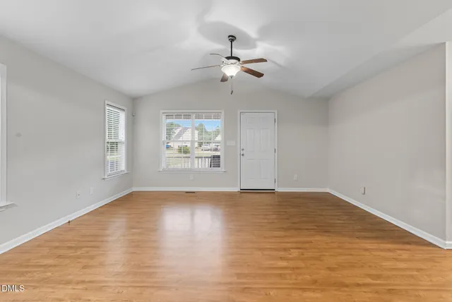 a view of a balcony with wooden floor and outdoor seating