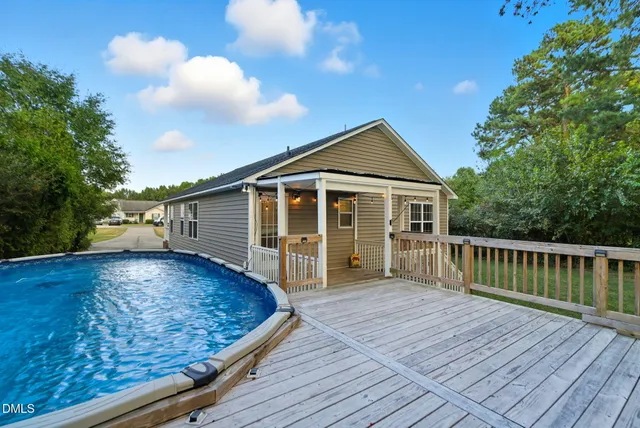 a view of a two chairs in the balcony next to a yard