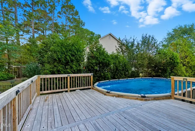 a view of a house with a wooden deck