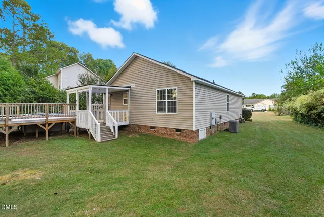 a view of balcony with wooden floor and outdoor seating