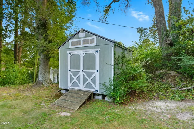 a view of a house with a yard and sitting area