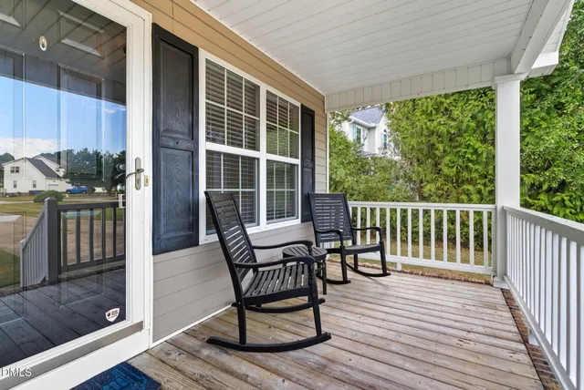 a view of a house with backyard sitting area and garden