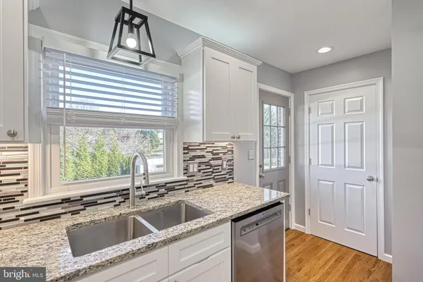 a kitchen with a sink and a refrigerator