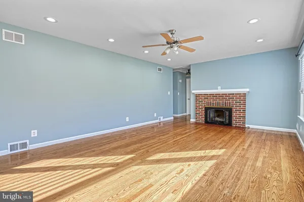 a view of an empty room with a fireplace