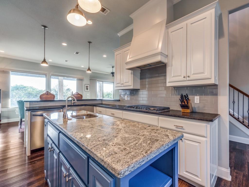 165 Cote D Azur Chico, TX 76431 - Photo 12 of 40 a kitchen with stainless steel appliances granite countertop a sink a stove and a wooden floors