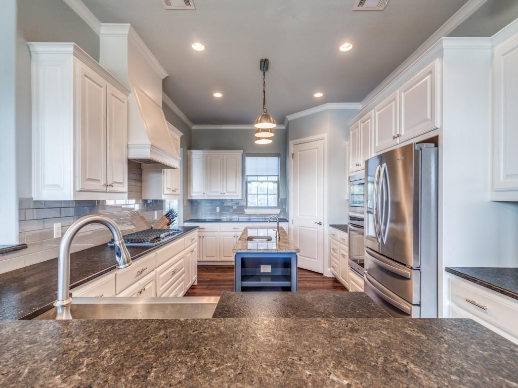 165 Cote D Azur Chico, TX 76431 - Photo 13 of 40 a kitchen with granite countertop a refrigerator and a sink