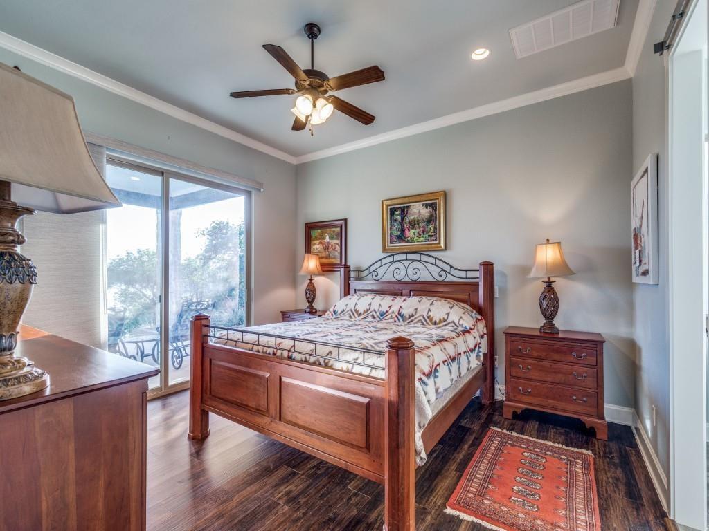 165 Cote D Azur Chico, TX 76431 - Photo 15 of 40 a bedroom with a bed and a chandelier