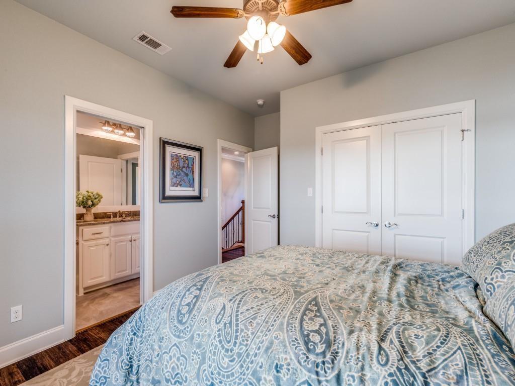 165 Cote D Azur Chico, TX 76431 - Photo 22 of 40 a bedroom with a bed and a chandelier