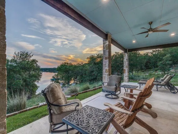 a view of a patio with a dining table and chairs