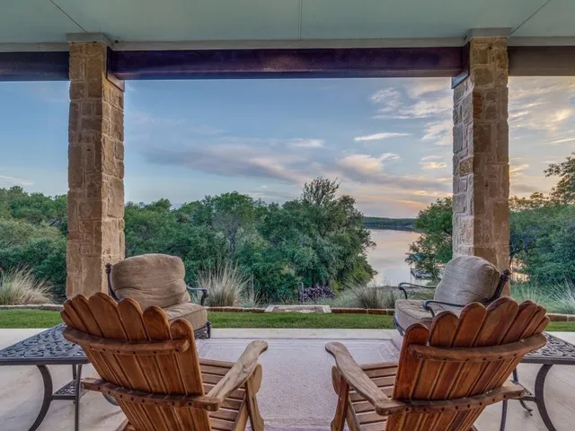 a view of a patio with a table chairs and a floor to ceiling window