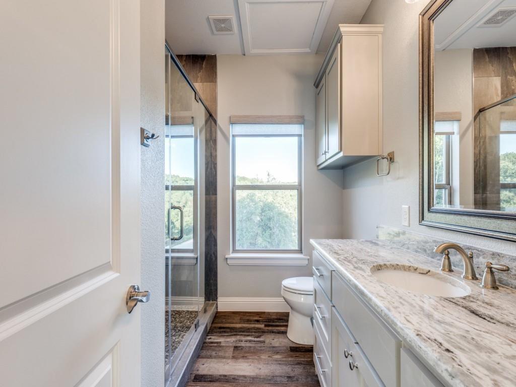 165 Cote D Azur Chico, TX 76431 - Photo 32 of 40 a bathroom with a granite countertop sink toilet and shower