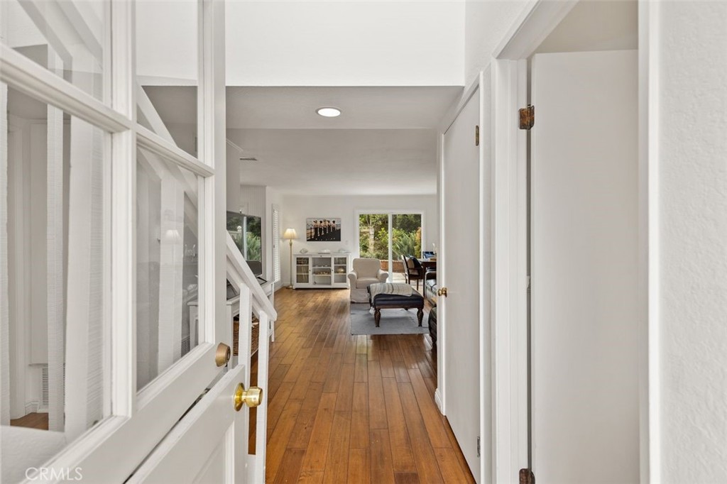 a view of a hallway view with wooden floor and furniture