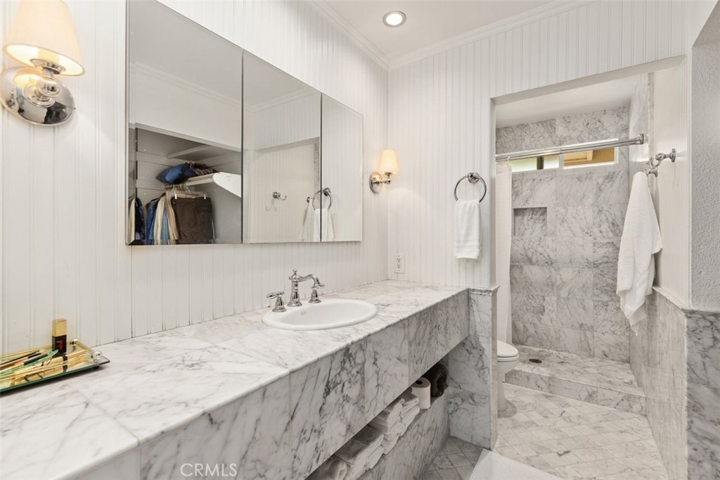 33482 Spinnaker Drive South Dana Point, CA 92629 - Photo 16 of 27 a bathroom with a granite countertop sink a mirror and shower