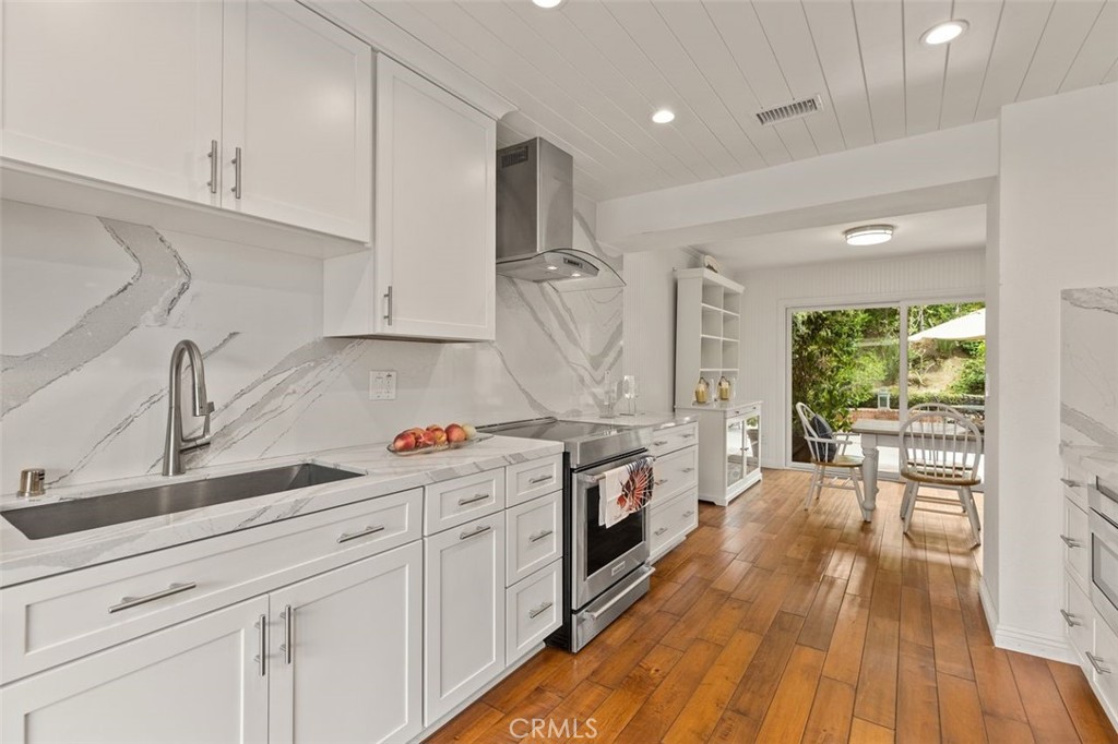 33482 Spinnaker Drive South Dana Point, CA 92629 - Photo 9 of 27 a kitchen with granite countertop a sink cabinets stainless steel appliances and a wooden floor
