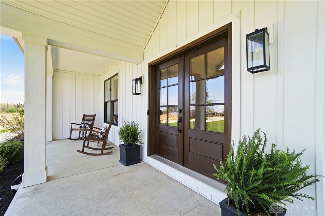 This charming front porch welcomes you with a classic farmhouse appeal.