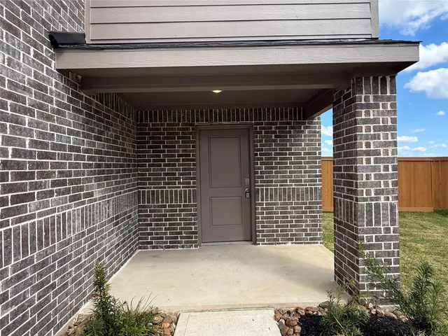 a view of kitchen and empty room with wooden floor