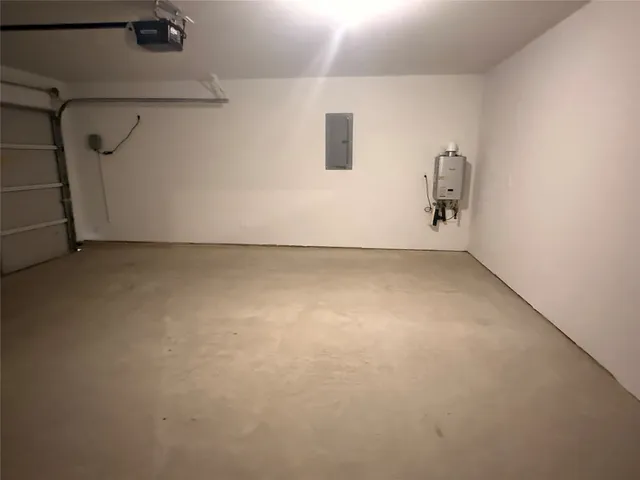 a view of a kitchen with wooden floor electronic appliances and window