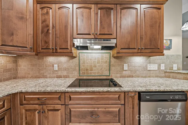 a kitchen with granite countertop a sink and cabinets