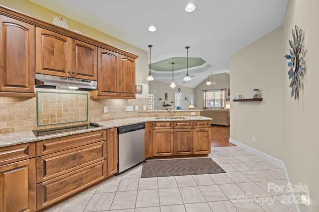 a kitchen with stainless steel appliances granite countertop a sink and cabinets