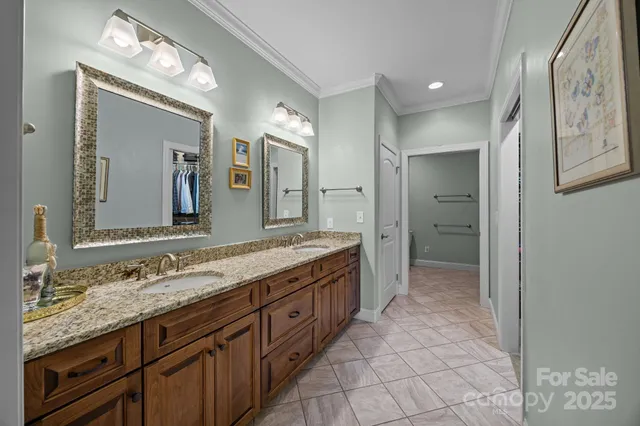 a bathroom with a granite countertop sink a mirror and a shower