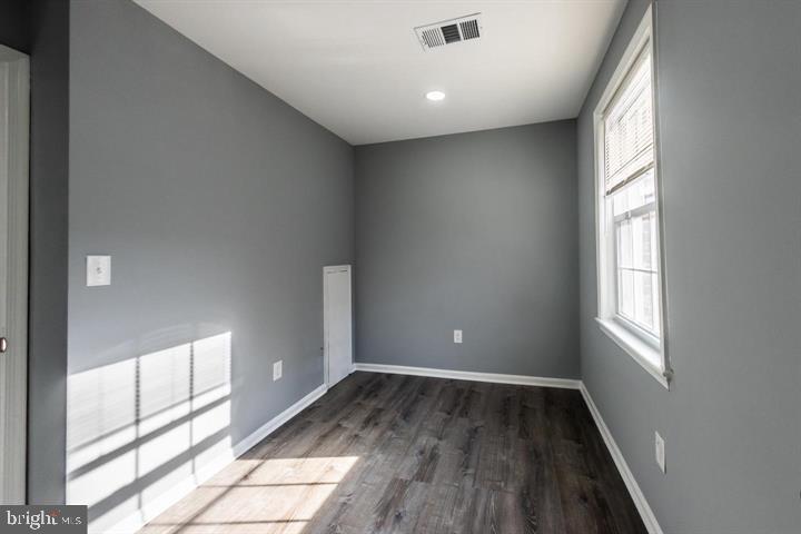 2055 38th Street Southeast, Unit 102 Washington, DC 20020 - Photo 3 of 7 a view of empty room with wooden floor and fan