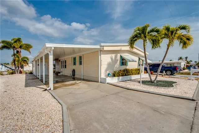 a dining room with furniture a chandelier and wooden floor
