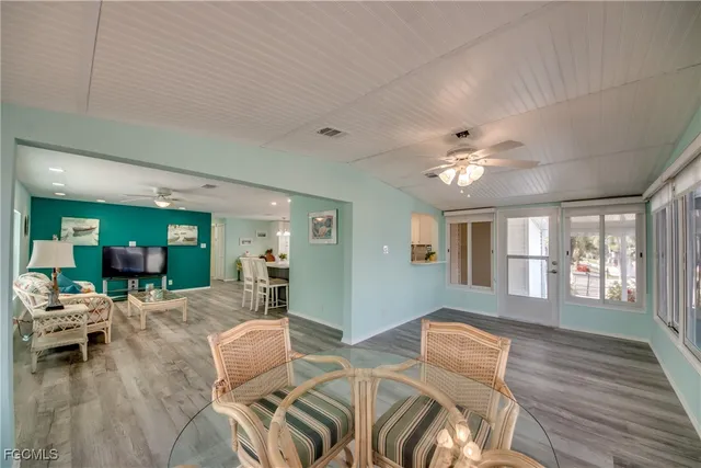 a view of a dining room with furniture wooden floor and chandelier