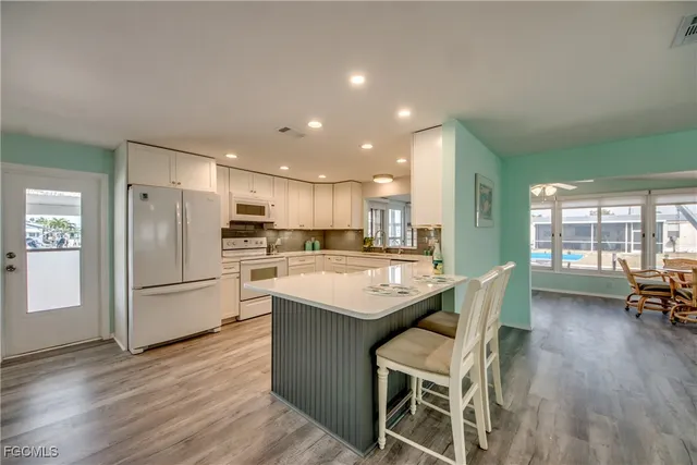 a view of kitchen with dining table and chairs