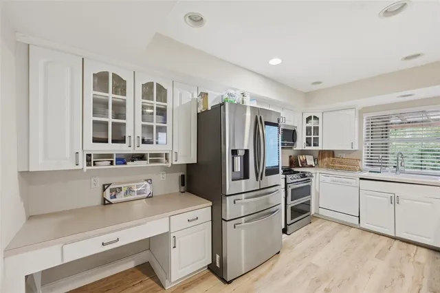 a kitchen with granite countertop cabinets and stainless steel appliances