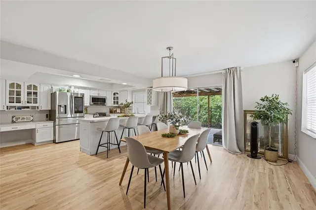 a dining room with furniture window and wooden floor