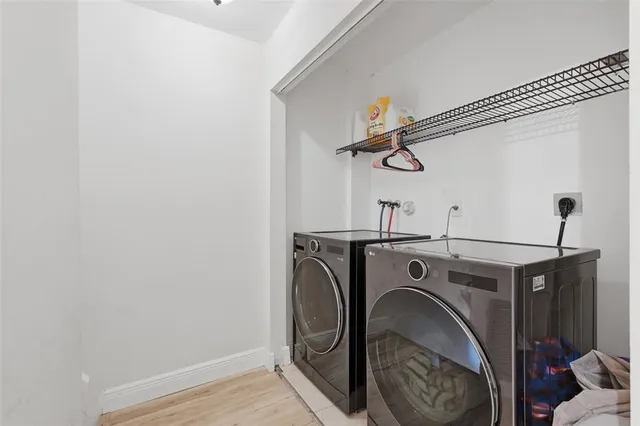 a view of storage and utility room with washer and dryer