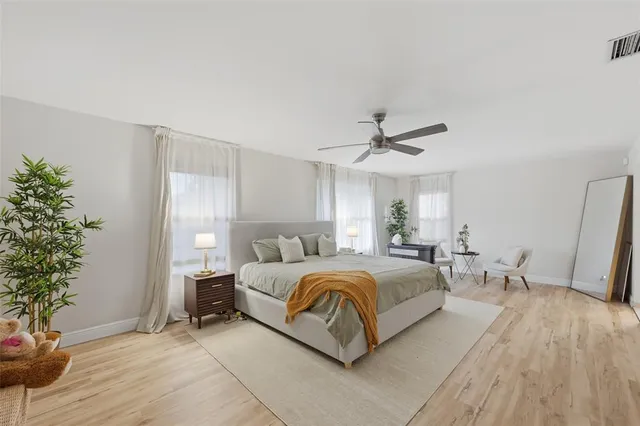 a bedroom with a bed and a potted plant
