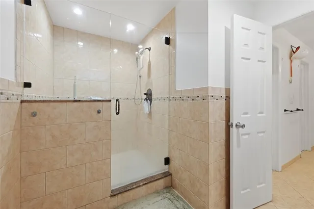 a bathroom with a shower and a glass door